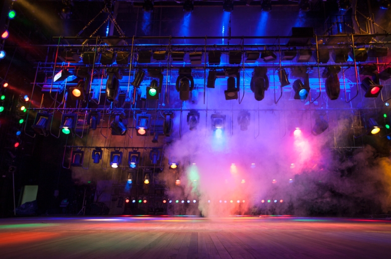 Empty stage with colorful lights and smoke machine fog